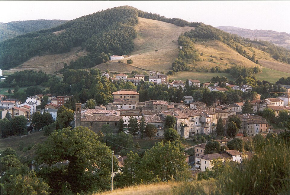 Panoramic view of Apecchio village set among the green hills of the Marche Apennines