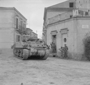 The British Army in Italy 1943 A Sherman tank of 'B' Squadron, Warwickshire Yeomanry, passing Indian infantry in Frisa,